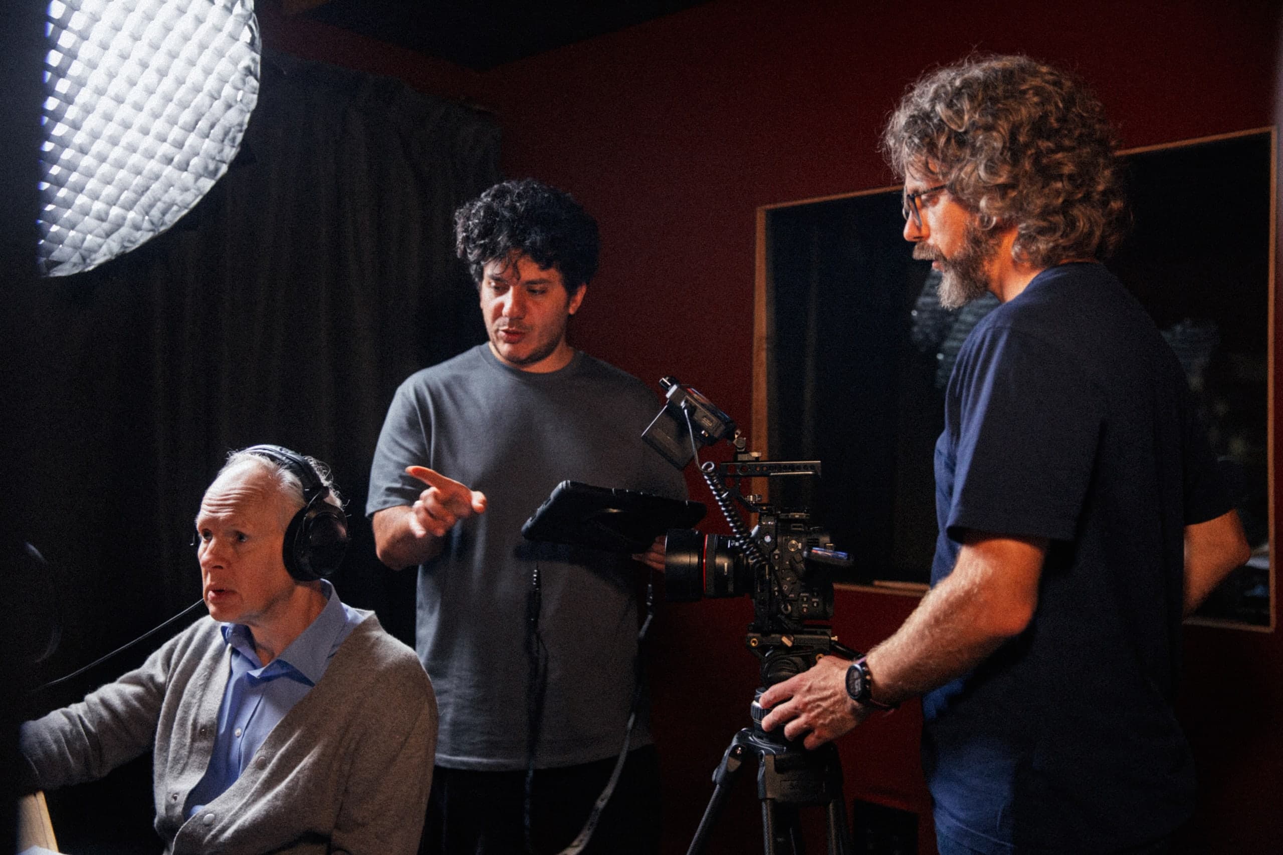 Reviewing a take around the monitor, headphones on